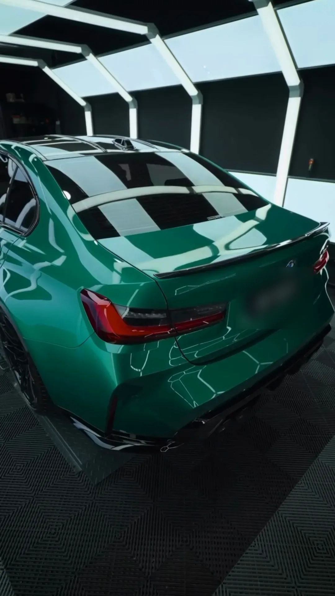 Rear three-quarter of a gloss green BMW M4